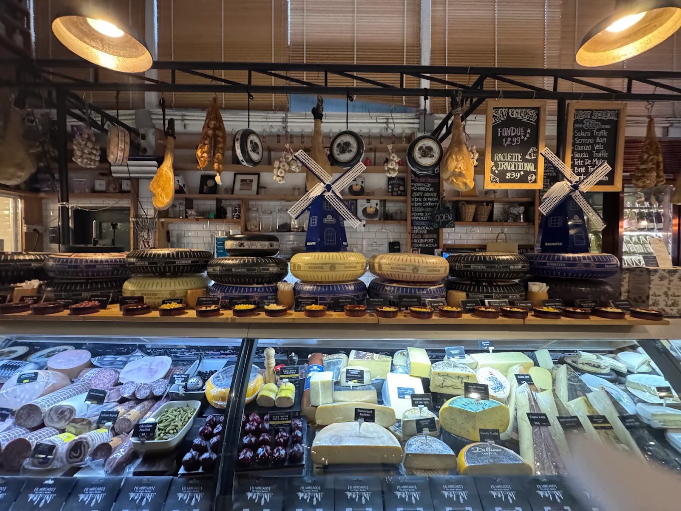 Dutch cheese wheels stacked above the cheese cabinet